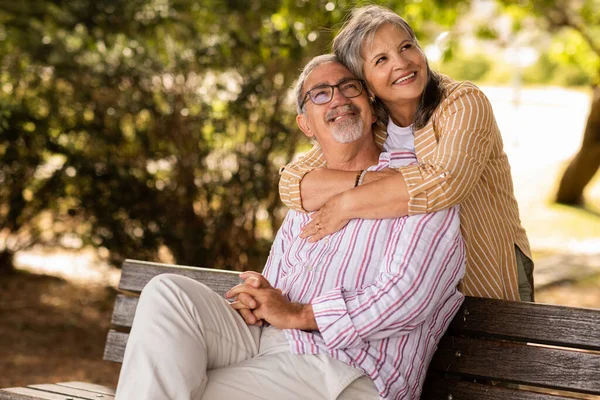 Smiling Senior Caucasian Wife Hugging Husband Sit Bench Have Fun — Stock Photo, Image