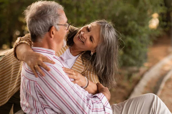 Glad Senior Caucasian Woman Hugging Husband Sitting Bench Have Fun — Stock Photo, Image