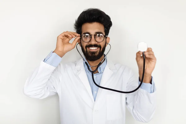 안경을 청진기를 사용하여 코트를 매혹적으로 잘생긴 아라파 의사는 카메라 미소를 — 스톡 사진