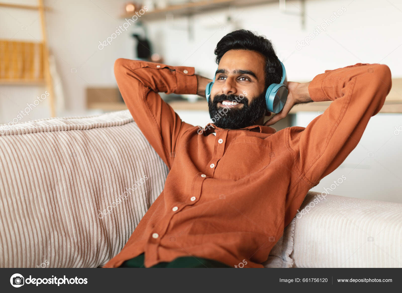 Cheerful Bearded Indian Man Listening Music Wireless Headset Home