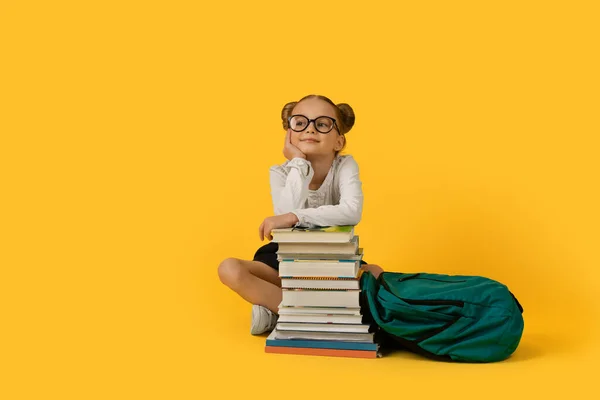 Schattig Basisschool Meisje Zitten Boeken Stapelen Yelow Achtergrond Glimlachen Dromerig — Stockfoto