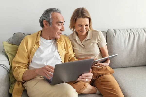 Dizüstü Bilgisayarlı Dijital Tabletli Koltukta Oturan Mutlu Yaşlı Eşler Nternet — Stok fotoğraf