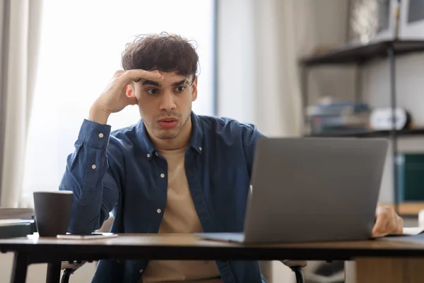 Workplace Issue. Bored Middle Eastern Guy Sitting At Laptop Hating His Boring Job, Tired After Work Day In Modern Office. Professional Burnout, Business And Entrepreneurship Problem Concept
