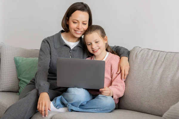 Positive Millennial Caucasian Lady Hugs Teen Daughter Have Video Call — Stock Photo, Image