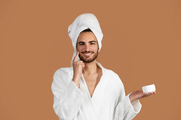 Portrait Smiling Latin Man Moisturizing Face Applying Cream Holding Jar — Stock Photo, Image