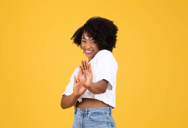 Happy millennial black woman in casual making stop gesture with hands, isolated on orange studio background. Personal space, fun, human emotions, say no, lifestyle and ad, offer clipart