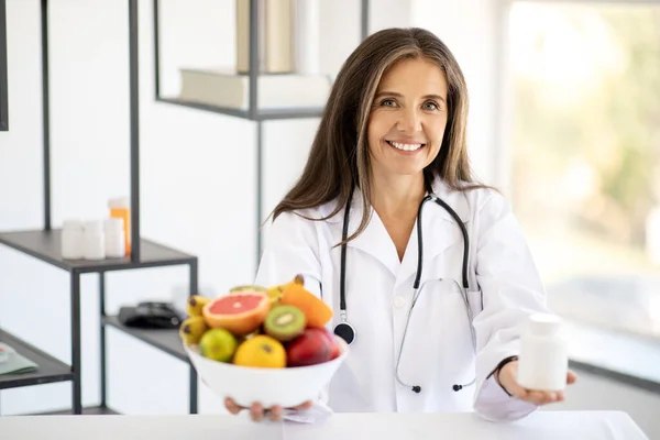 Smiling Adult European Woman Doctor Nutritionist White Coat Offers Jar — Stock Photo, Image