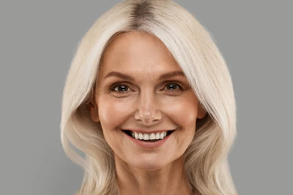 Closeup Portrait Smiling Attractive Mature Woman Blonde Hair Posing Grey — Stock Photo, Image