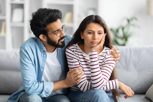 stock image Compassionate eastern husband giving comfort, support to upset wife, holding shoulders, speaking expressing empathy. Man feeling guilty, asking girlfriend to forgive. Relationship, compassion concept