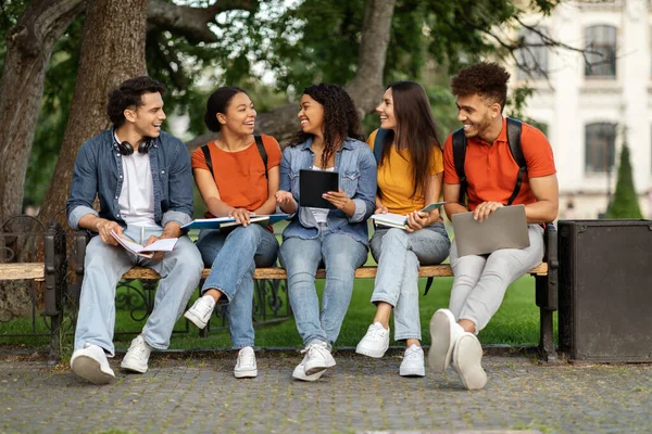 Üniversite Kampüsünde Dışarıda Bankta Oturan Farklı Öğrenci Arkadaşları Birlikte Dinlenen — Stok fotoğraf