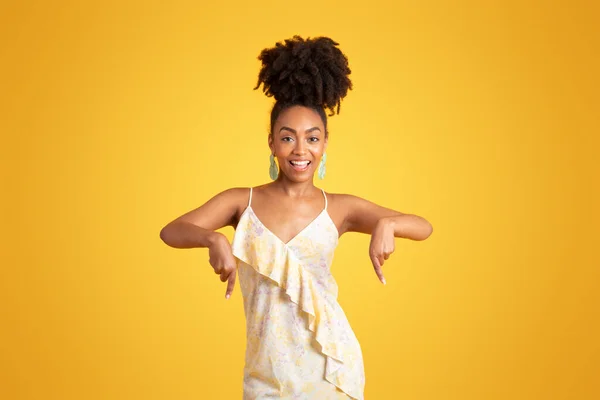 兴高采烈的年轻黑人妇女指指点点空旷的空间 推荐出售 孤立在黄色背景下的工作室 广告和提供 生活方式 巨大的销售建议 好消息 — 图库照片