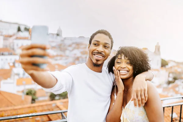 Satisfied young african american guy hug woman with ring, taking selfie of engagement, enjoy date, holiday and travel, outdoor. Love, relationship, app for video call, photo and romance