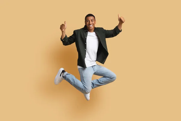 Happy Cheerful Handsome Casual Millennial Black Man Jumping Air Showing — Stock Photo, Image