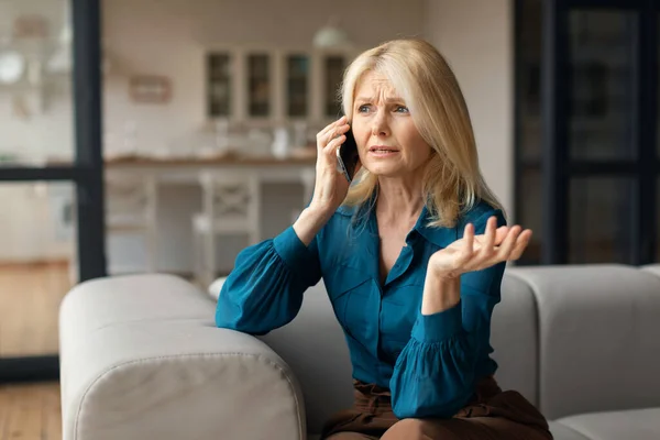 Stressed Mature Woman Talking Cellphone Having Unpleasant Phone Conversation While — Stock Photo, Image