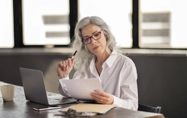 stock image Hiring Concept. Human Resources Manager Woman Reading Candidate CV, Holding Paper And Evaluating Resumes And Job Applications Sitting At Laptop In Modern Office. Business Career And Employment