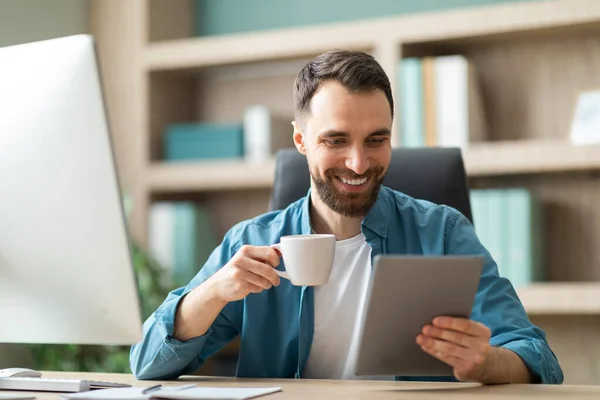 Веселый Молодой Бизнесмен Сидящий Рабочим Столом Пьющий Кофе Пользующийся Цифровым — стоковое фото
