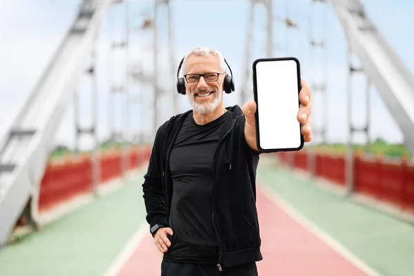 Cheerful Elderly Sportsman Wearing Black Sportswear Wireles Headphones Standing Empty — Stock Photo, Image