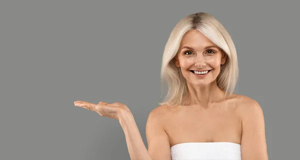 Place Beautiful Mature Lady Advertising Something Her Empty Palm Smiling — Stock Photo, Image