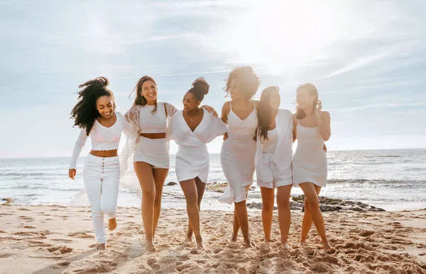 Brides team. Happy young multiracial women walking to camera, having fun at maiden evening near ocean, ladies embracing and smiling, full length