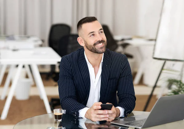 Glad confident caucasian mature man in suit uses laptop and smartphone to manage business, looks up at copy space in coworking office interior. Ad, offer, businessman, teacher, manager work, device