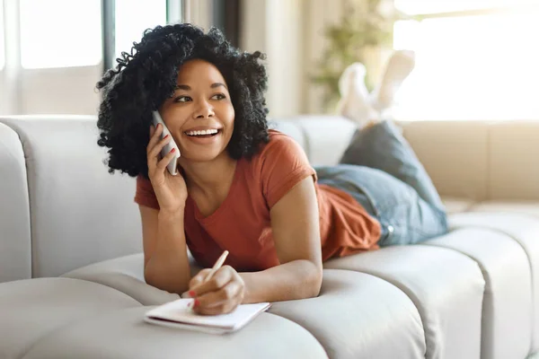 Cep Telefonuyla Konuşan Mutlu Siyahi Kadın Portresi Evdeki Koltuğa Uzanmış — Stok fotoğraf