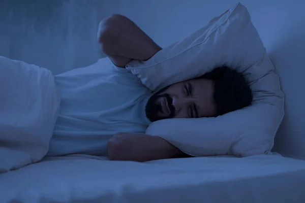 Sleeping Problem Stressed Indian Man Covering Head Pillow While Lying — Stock Photo, Image