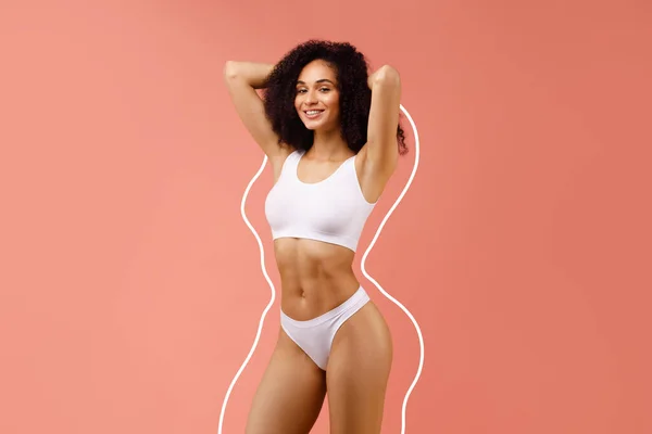 Bodycare and sculpting concept. Happy african american young lady in white top bra and panties posing with chubby body lines around her body isolated on pink studio background, collage