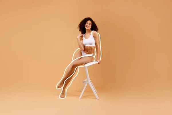 完美的体形和自然美的概念 身穿白色内裤的瘦小黑人女士坐在椅子上 在米色工作室的背景上摆出姿势 展示了饮食效果 全身而退 自由自在 拼贴在一起 — 图库照片