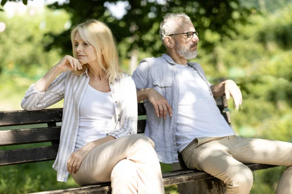 Relationship Crisis. Offended Mature Husband And Wife Sitting On Bench In Park After Argue, Senior Man And Woman Suffering Problems In Relations, Married Couple Angry After Quarrel, Copy Space