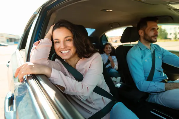 一家人开着车快乐 女人笑着对着镜头坐在乘客座位上 享受着乘坐新车旅行的乐趣 父母和女儿开车外出度假 有选择的重点 — 图库照片