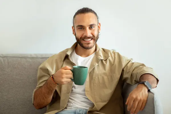 Portrait Cheerful Handsome Bearded Millennial Man Casual Sitting Couch Holding — Stock Photo, Image