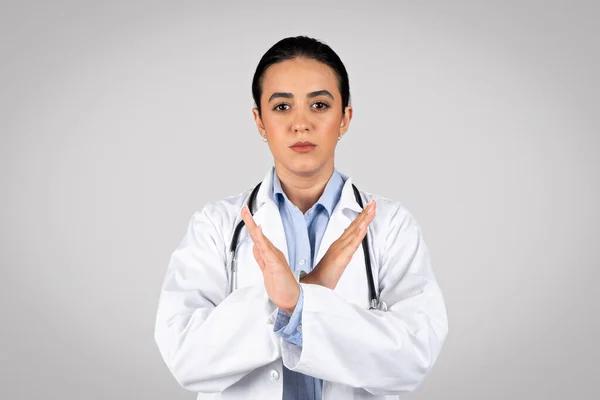 Serious Latin Woman Doctor Showing Stop Gesture Her Hands Symbolizing — Stock Photo, Image