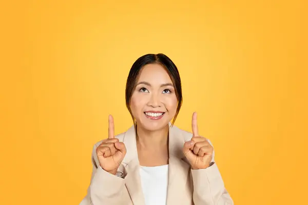 Glad Asian Millennial Woman Point Fingers Free Space Isolated Orange — Stock Photo, Image