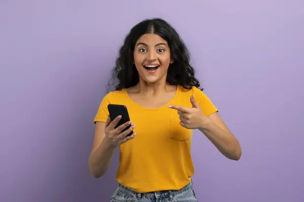 Excited Cheerful Pretty Curly Young Indian Woman Student Pointing Phone — Stock Photo, Image
