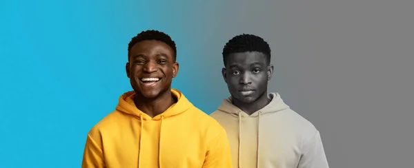 stock image Smiling, unhappy millennial black guy suffer from depression, stress on blue and gray background, panorama. Mental problems, negative emotions, psychological latent disease