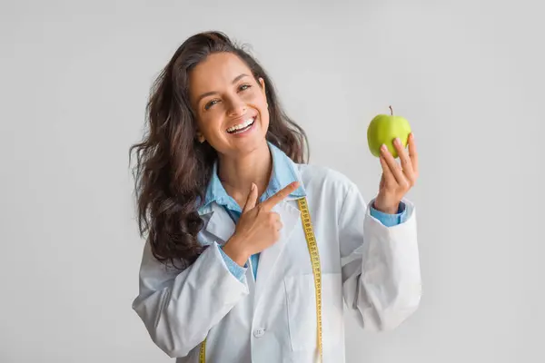 Cheerful Nutritionist Holding Fresh Green Apple Hand Pointing Standing Tape — Stock Photo, Image