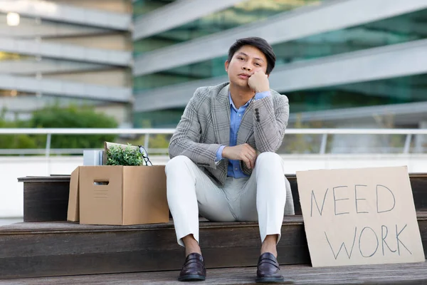 Kwestia Bezrobocia Nieszczęśliwy Zwolniony Azjatycki Pracownik Biznesowy Siedzi Papierowym Napisem — Zdjęcie stockowe