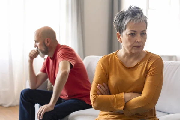 Marital Crisis. Upset Senior Woman Offended After Argue With Husband At Home, Angry Pensive Lady Sitting With Folded Arms, Tired Of Domestic Conflicts With Spouse, Suffering Crisis In Relationship