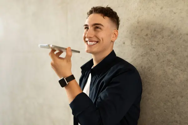 Happy handsome millennial european guy enjoy lifestyle, calling by smartphone in city, outdoor, copy space. Good news work, success business, study and conversation at free time