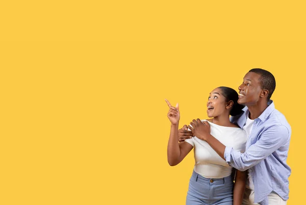 Excited Black Couple Embracing Pointing Copy Space Nice Text Isolated — Stock Photo, Image