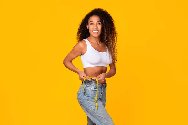 Black Millennial Lady Measuring Her Waistline Tape Smiling Confidently Studio — Stock Photo, Image