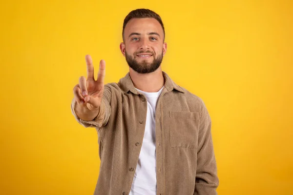 Smiling Millennial European Guy Beard Casual Make Peace Hand Sign — Stock Photo, Image