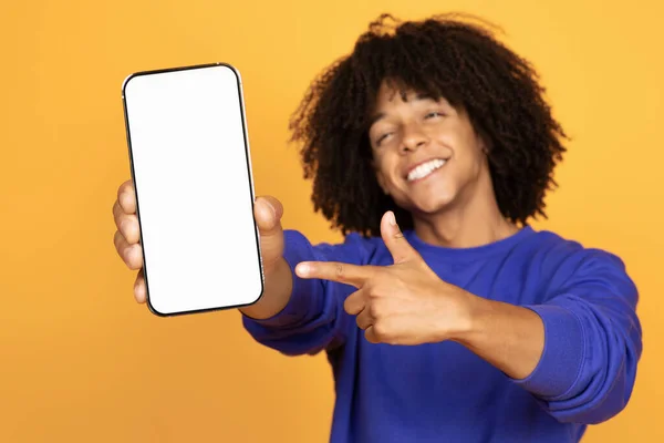 积极的黑人男子手持智能手机 在空白白屏前指点 快乐的年轻非洲裔美国人演示如何为你的应用程序或移动网站设计 大学生活 — 图库照片