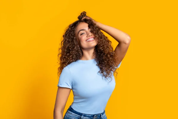 Radiant Woman Curly Locks Playfully Running Her Hand Her Hair — Stock Photo, Image