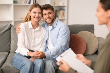 Uzlaşma için. Sevgili karı koca psikoterapist ofiste birlikte oturup sevgi ve anlayış göstererek çift terapisi yolculuğunun olumlu sonucunu gösteriyor.
