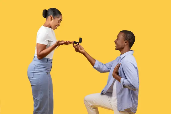 Delighted Young Black Woman Looks Open Ring Box Man Kneels — Foto Stock