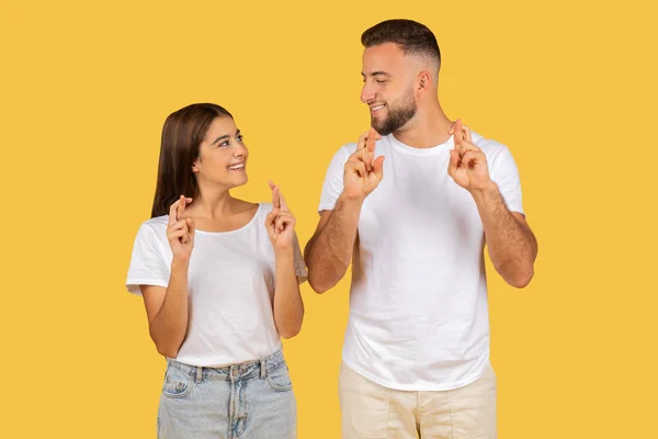 Optimistic Glad European Young Couple White Shirts Fingers Crossed Smiling — Stock Photo, Image