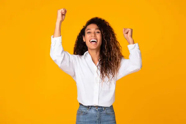Joyful Black Woman Shaking Fists Raising Arms Victory Smiling Camera — Stockfoto