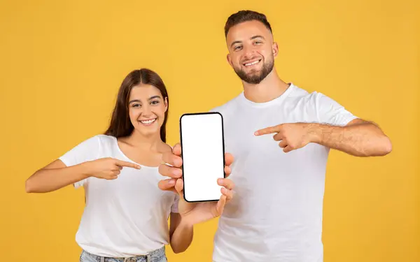 Smiling Caucasian Young Woman Man White Shirts Holding Pointing Smartphone — Stok fotoğraf