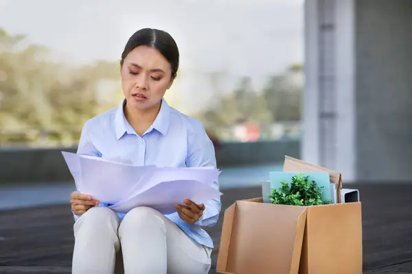 Jobless Korean Business Woman Looking Employment Papers Sitting Belongings Box — Stockfoto